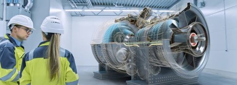 Two engineers in safety gear are examining a large industrial turbine with an augmented reality (AR) overlay.